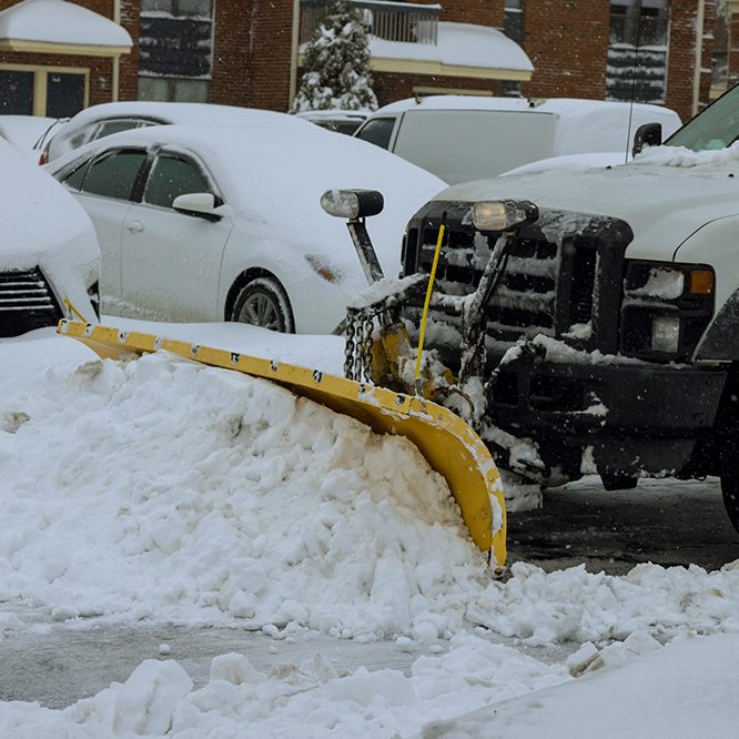 during,heavy,snowfall,,snowplow,truck,removes,snow,from,parking,lot