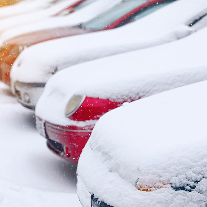 snow,covered,cars,on,snowy,parking,lot,,frozen,car.,vehicles