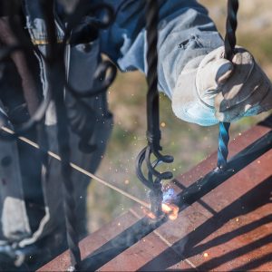 a,worker,welding,metal,handrails,on,the,stairs.,wrought,iron